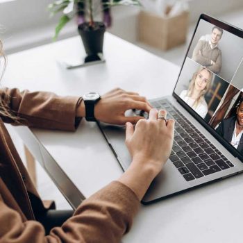 Woman communicating with team over video chat